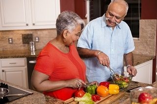 older woman and man cooking
