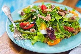 salad on blue plate with fork