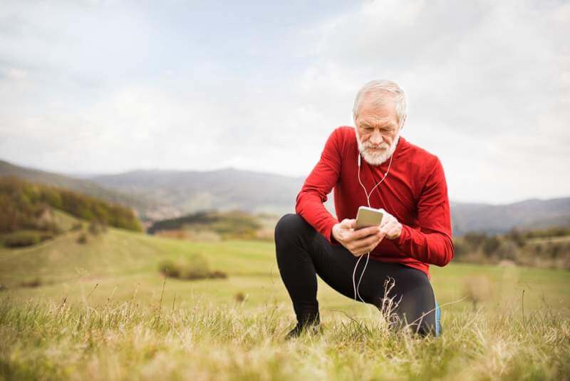active-senior-runner-in-nature-with-smart-phone