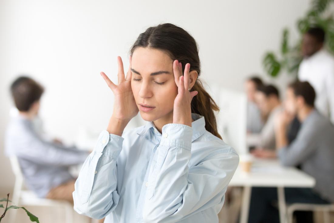 Woman holding her head due to dizziness and loss of balance