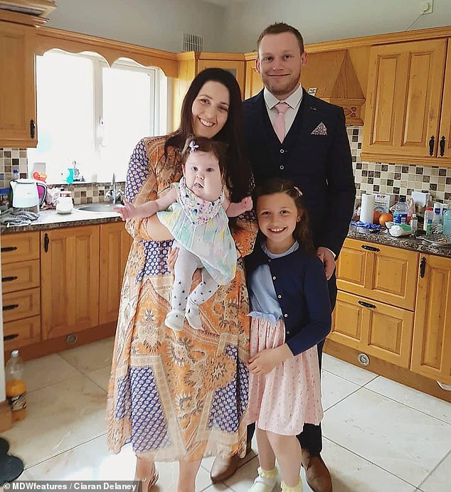 Evie was unable to breathe for herself after she was delivered, with doctors saying the cysts were blocking her airways (pictured with parents Ciaran Delaney, Katie Nolan and sister Aila)