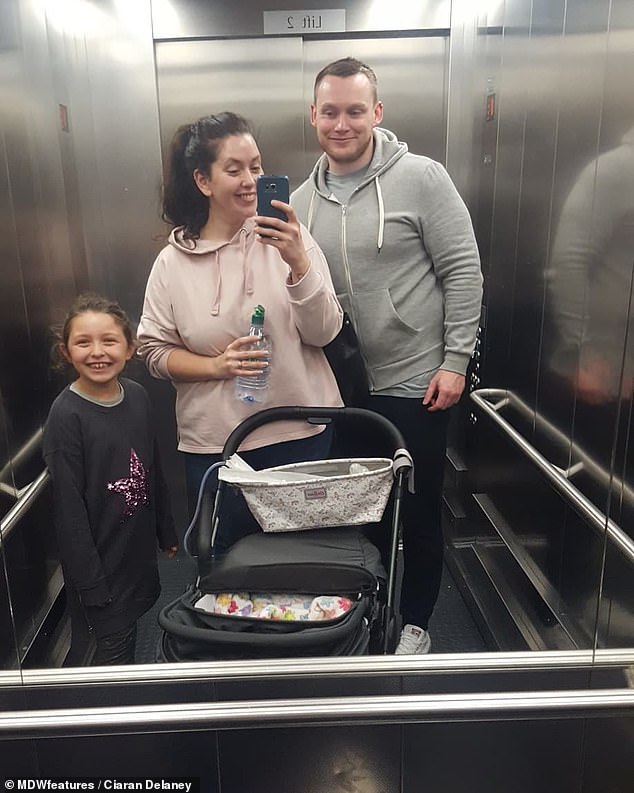 Mr Delaney, his wife and their daughter Aila are pictured in an elevator
