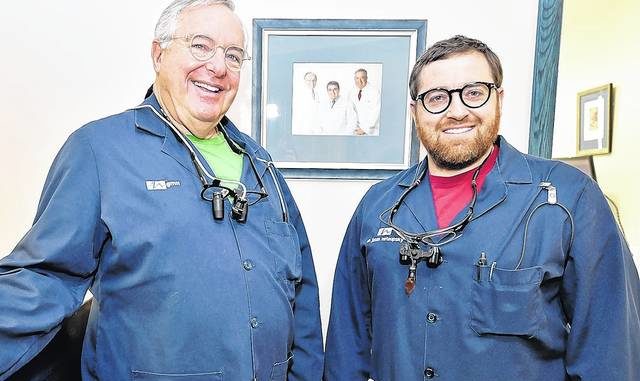  			 				                                Gary Nataupsky D.M.D and his son, Jason Nataupsky D.M.D, stand near a photo in the family dental office of themselves and their predecessor, Dr. Daniel Gordan. They are a three-generation dental office.                                  Aimee Dilger | Times Leader  			 		