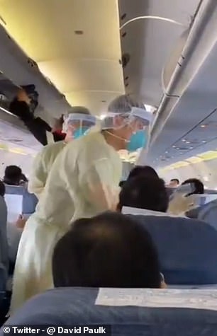 Footage on social media purports to show medics in hazardous material suits checking Chinese passengers one by one with thermometers