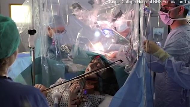 An incredible video shows Dagmar Turner, 53, playing the violin while surgeons at King's College Hospital removed a tumour from her brain
