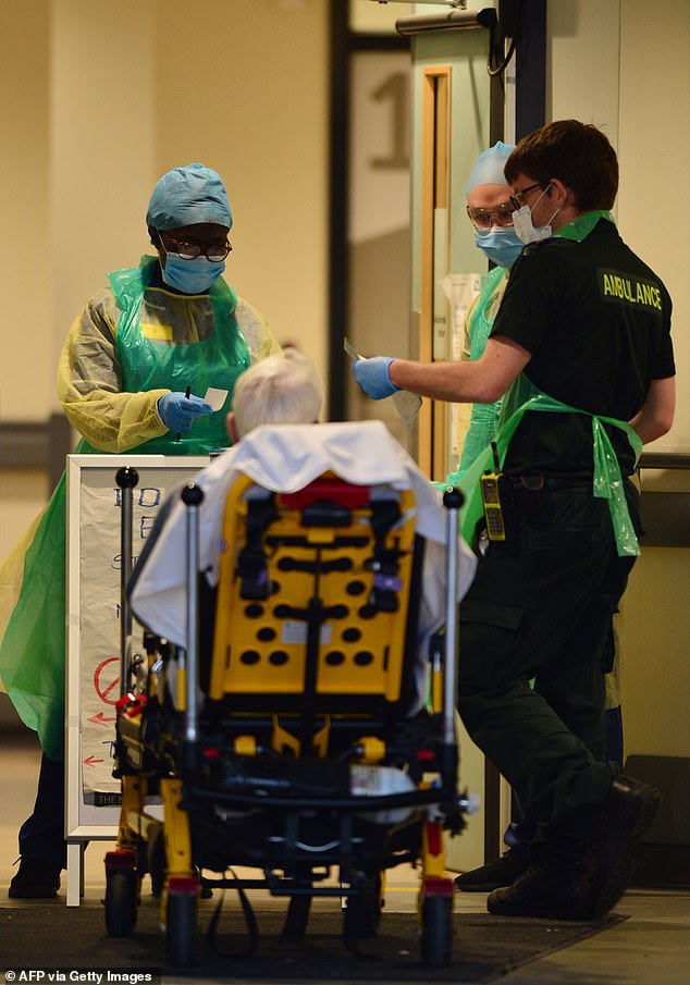 Pictured, medics wearing PPE at Aintree University Hospital, Liverpool