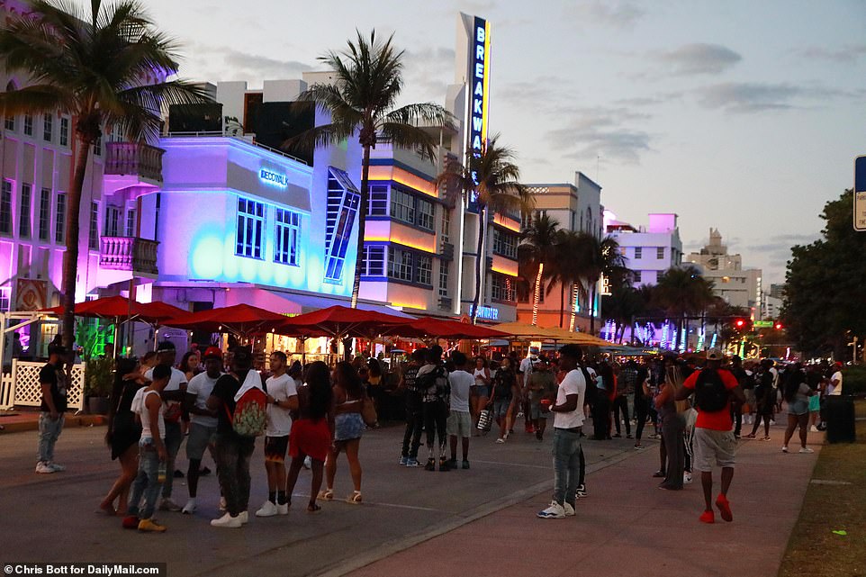 US coronavirus cases could be set to surge again in the Sunshine State and countless Spring Breakers continue to party in the streets despite police patrols and curfews in destinations like South Beach in Miami. Pictured: crowds ignore social distancing guidelines on Ocean Drive in South Beach, Miami on Monday